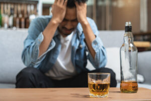 Young man drinking alcohol too much.