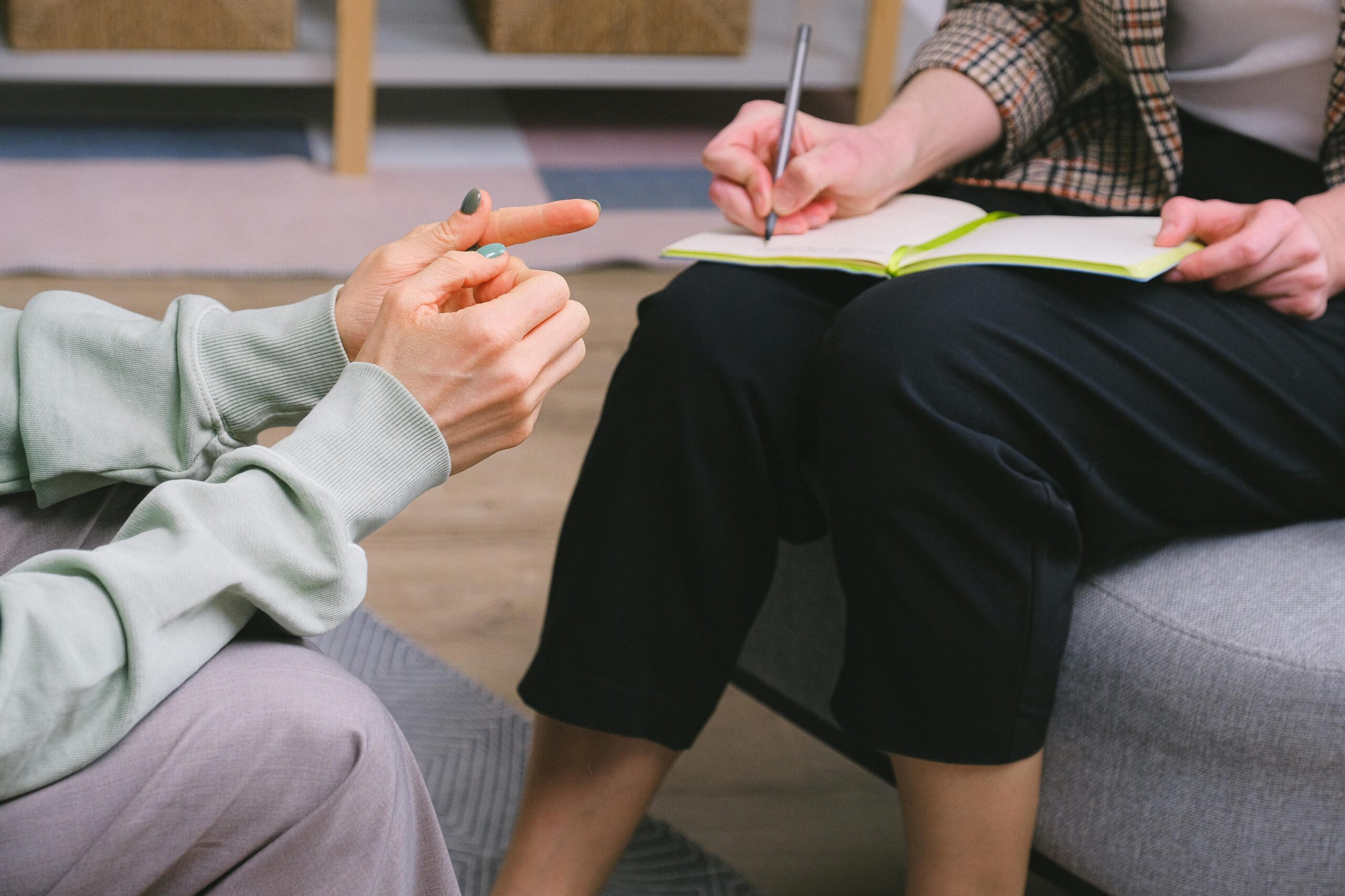 Therapist taking notes while speaking with client during sex addiction treatment at Breakaway Health in Costa Mesa, California.