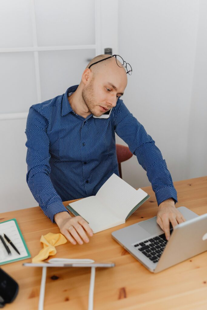 Man working remotely during outpatient rehab program while balancing addiction recovery, work responsibilities, and mental health treatment at home