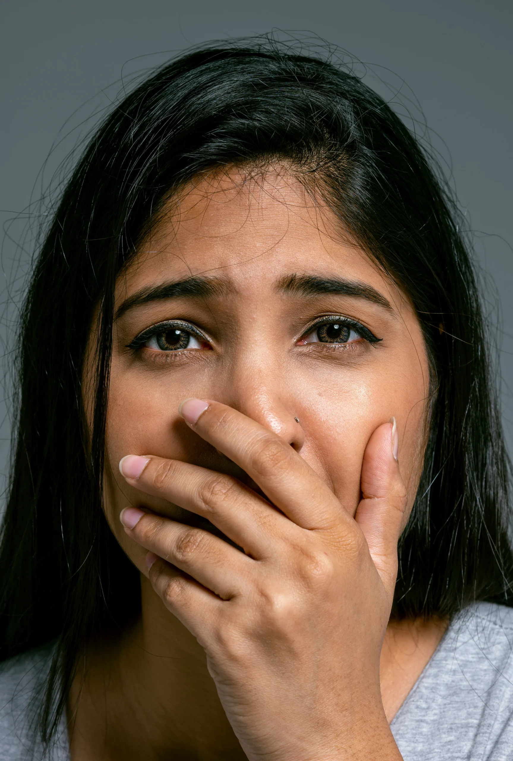 Woman showing visible signs of anxiety, fear, and emotional distress related to mental health and anxiety disorders.