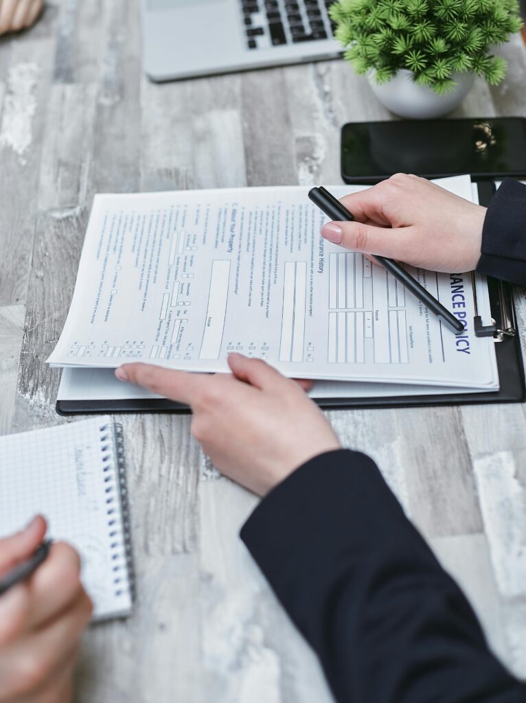 Health Net insurance representative reviewing healthcare coverage and treatment policy options with a client during an insurance consultation appointment.