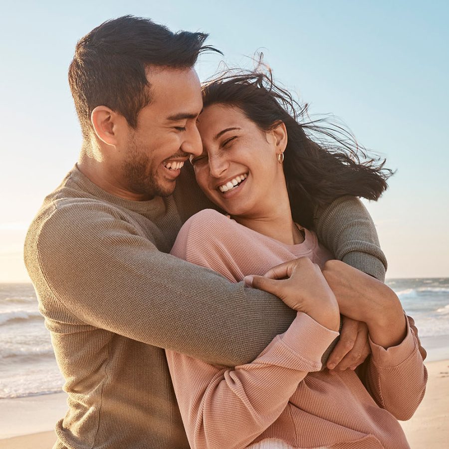 Happy couple hugging on a beach